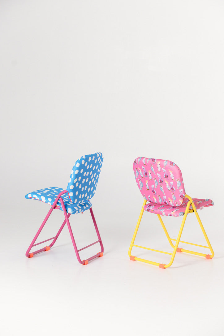 Two colourful folding chairs with polka dot seats designed for indoors and outdoors