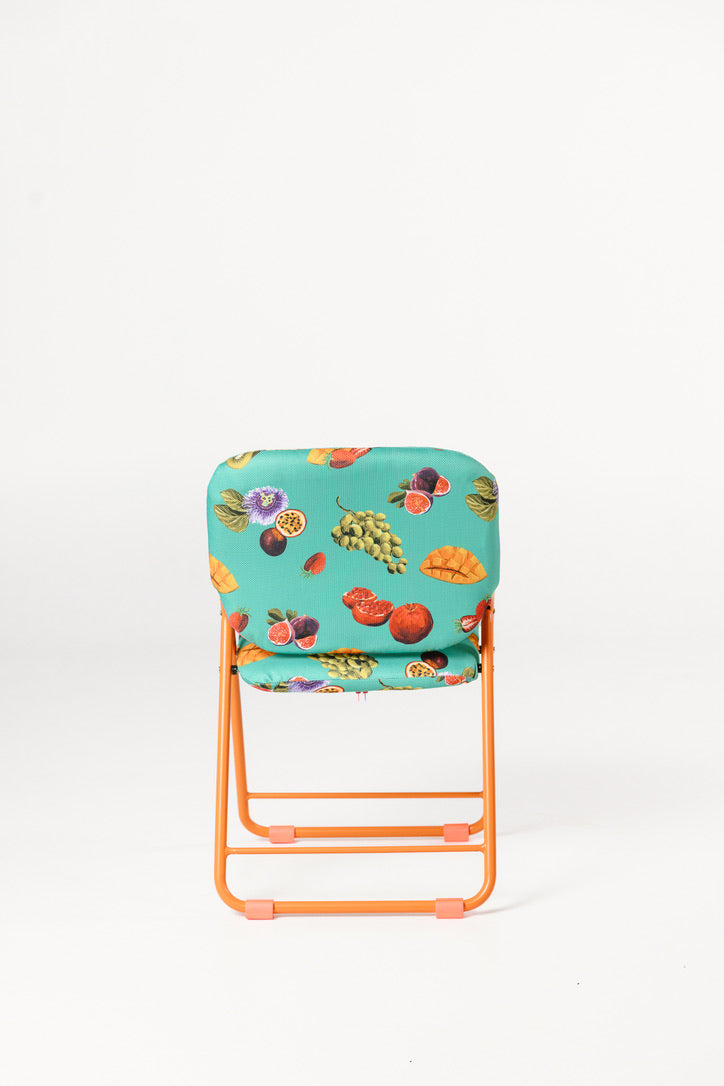 Foldable chair with a floral cushion on a white background