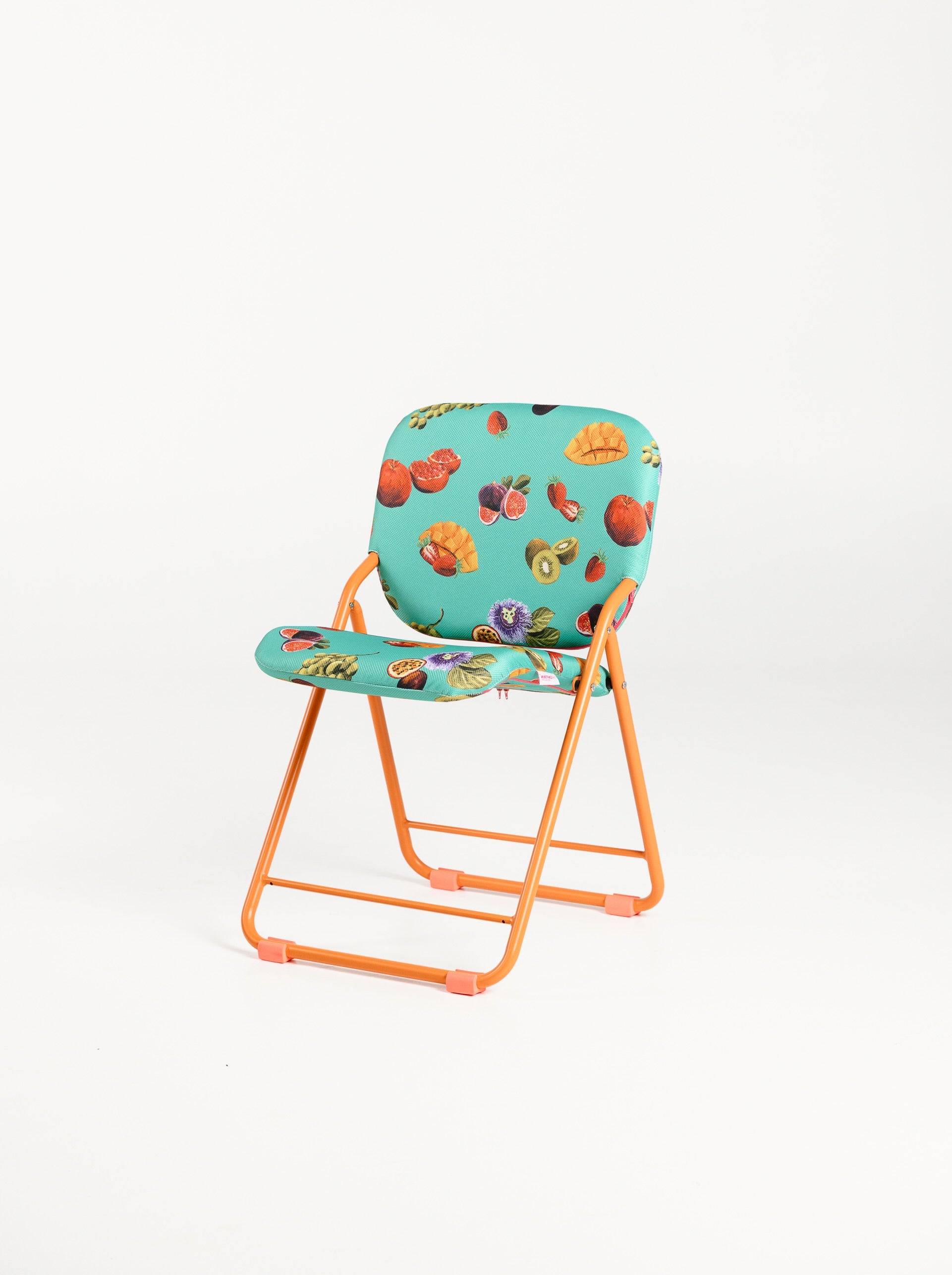 Folding chair with fruit patterned seat on a white background for indoors and outdoors